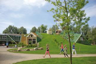 The green roof converts the unusual "Like-A-Leaf" architecture of the playhouse into a green hill. © ZinCo / Van der Tol Pitched green roof